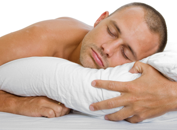 Man in bed sleeping peacefully with a pillow